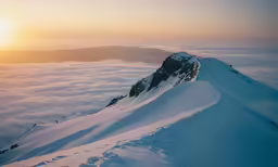 an aerial view of the top of a mountain in winter