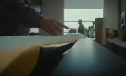 a person sitting at a table with an object in front of him