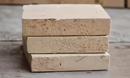 five bricks stacked on top of each other in the process of being made
