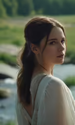 a woman in white shirt with long hair looking off to the side