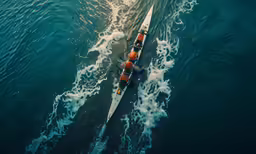an aerial view of a boat on a body of water