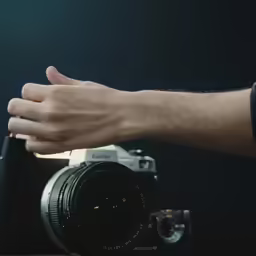 a hand holding a camera that has the camera on it