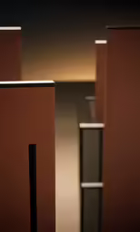 three tall brown vases with white and black accents
