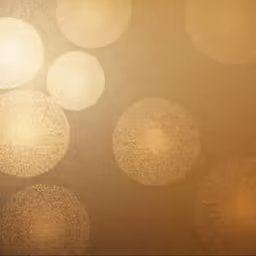 golden, textured background with small round white dots