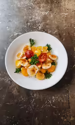 bananas and orange slices with tomatoes on a white plate
