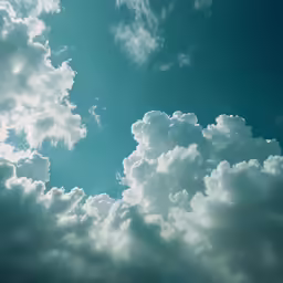 a blue sky with some white clouds and green trees