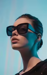 a beautiful young woman in black sunglasses posing for the camera