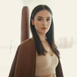 a woman wearing a tan bra posing for a photo