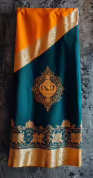 the silk monogrammed gold and teal design is very unique