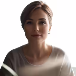 the woman is wearing a short shirt near a window