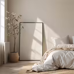 the bedroom has white linen on the floor and a tall vase