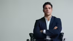 a man with a suit and tie in a wheelchair
