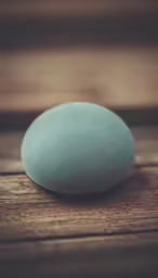 an oval blue object sitting on top of a wooden table