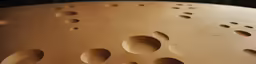 a close up of an abstract textured wooden sculpture with holes in the bottom