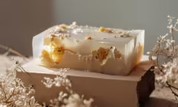 an unwrapped rectangular piece of soap on a surface
