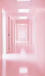 a long hallway with bright pink floors, and two doors