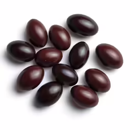 several nuts are stacked together on a white surface