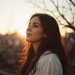 a girl with long hair smiling in the sun
