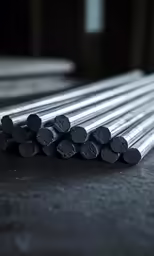 several steel bars are stacked up on a table