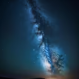 the milky is in the middle of a night sky