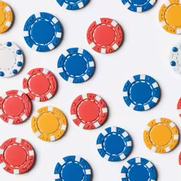 various colors and sizes of chips on a white background