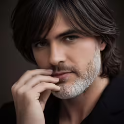 a bearded man with long hair and a goatee