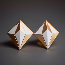 two origami objects sit on grey surface