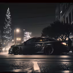 a couple of cars parked on a road near a tall tree