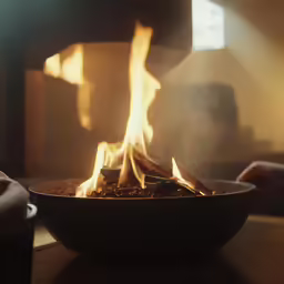 fire burning in a bowl inside of a kitchen