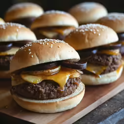 four cheeseburgers sitting on top of a cutting board