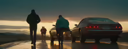 two people walking down the street with their dog