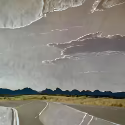 a road that is lined with sand dunes