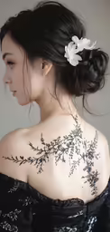 the back of a woman with a flower in her hair