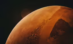 a orange planet with lots of dirt on top