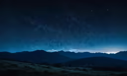 view of mountains and night sky with stars