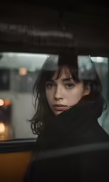 a woman stares out the window of a van