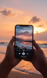 someone taking a photo with their cell phone at the beach