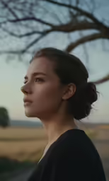 the woman is looking off into the distance
