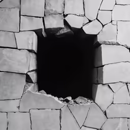 a hole in the ground with rocks around it