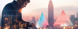 a person holding a laptop in front of some skyscrapers