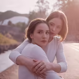 two women embracing each other on the street