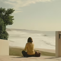 the young person is sitting on the edge of a wall