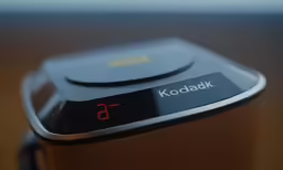 a small electronic device on a wooden table