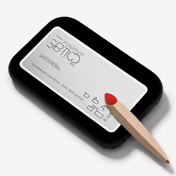 an image of a credit card and a wooden pencil