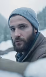 a man in winter attire looks into the camera