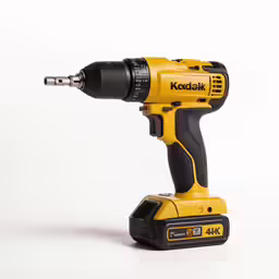 the yellow cordless drill is on the white surface