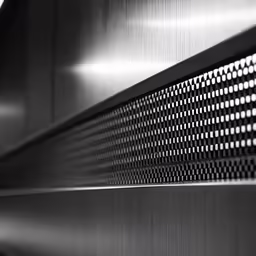 a metallic piece of metal with white and black circles