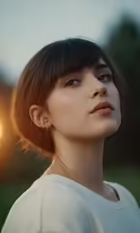 a woman wearing a white shirt is staring