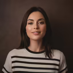 a women who is smiling and looking at the camera