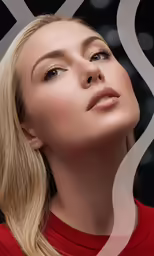 a blonde woman is wearing a red top and has her face in the air